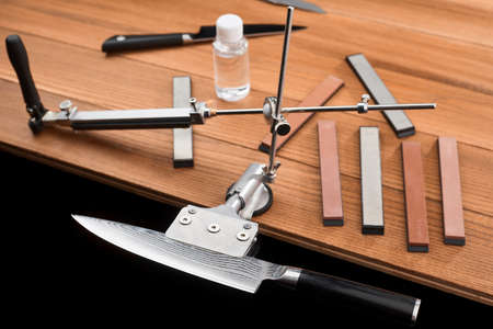 Japanese knife fixed in a manual sharpener machineの写真素材