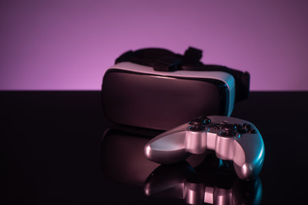Joystick and VR headset on dark violet background