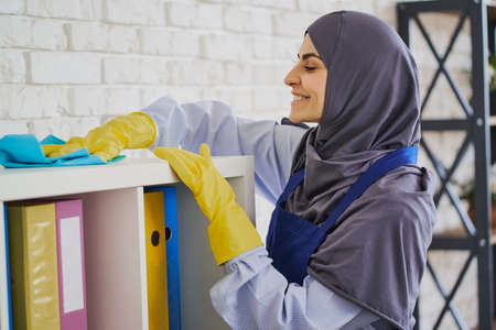 Arabian woman enjoys making an office cleanの写真素材