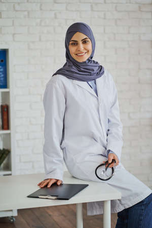 Portrait of a beautiful Muslim doctor in her cabinetの写真素材