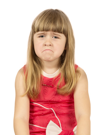upset little girl on the white background.の写真素材