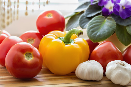 still life with tomatoes, pepper and garlic.の写真素材