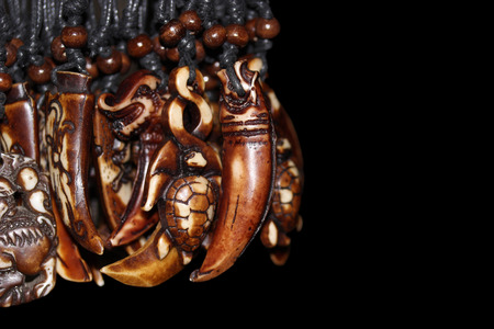 wooden pendant in the shape of  tusk.の写真素材