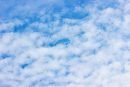 close up of blue sky with white clouds.