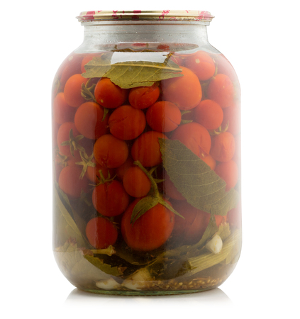 Marinated tomatoes canned in glass jar isolated on the white background.の写真素材