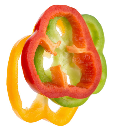 red, green and yellow pepper slices isolated on the white background.の写真素材