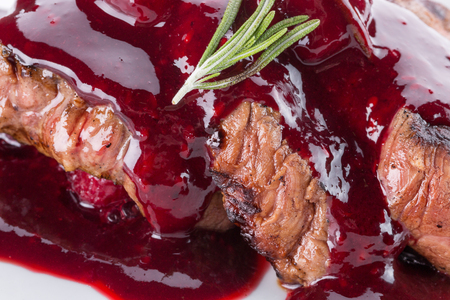 close up of sliced meat in cranberry sauce.の写真素材