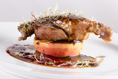 grilled chicken leg on caramelized apple.の写真素材