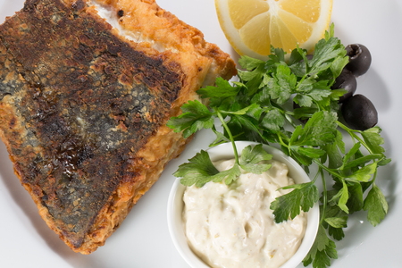 piece of fried fish with garnish.の写真素材