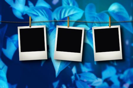 Photo cards on the grunge blue wall の写真素材