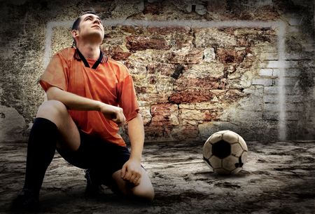 Football player and Grunge ball on the retro grunge backgroundの写真素材