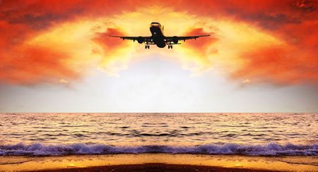 Beautiful sea nature landscape on the sunrise sky with airplaneの写真素材