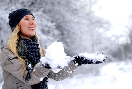 Young happy smiling blond girl outdoor in winterの写真素材