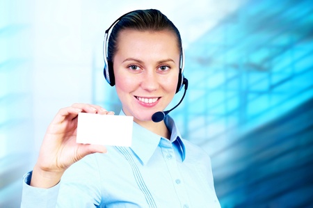 Happiness businesswoman speak in headphones on blur business architecture backgroundの写真素材