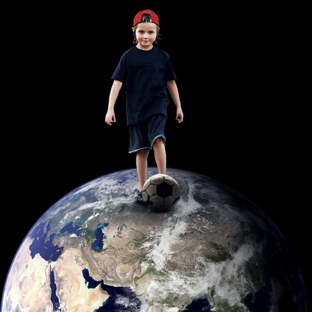 Child football player on the planetの写真素材