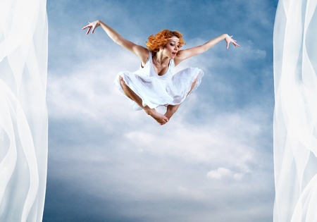 Jump of ballerina with dress of milk