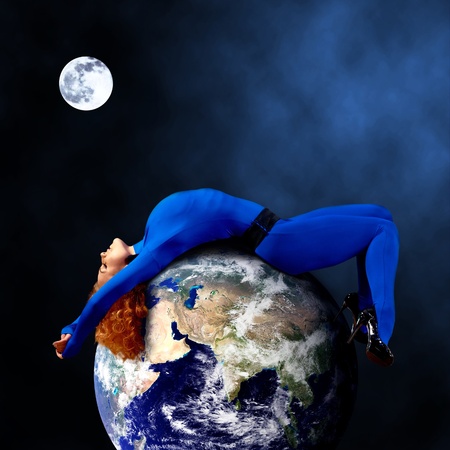 Woman in blue sleeping on the planet in space.の写真素材