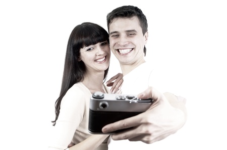 Young beauty couple with photo camera isolated on white backgroundの写真素材