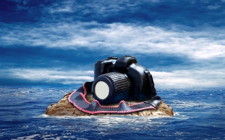 Cake from chocolate photocamera on the island in sea.の写真素材