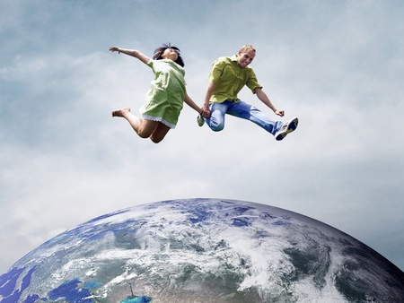 Fun couple in jump over the Planet Earthの写真素材
