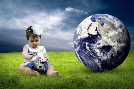 Happiness Baby girl sitting on the grass in fieldの写真素材