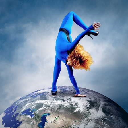 Ballerina stay in dancing pose on the Planet Earth.の写真素材