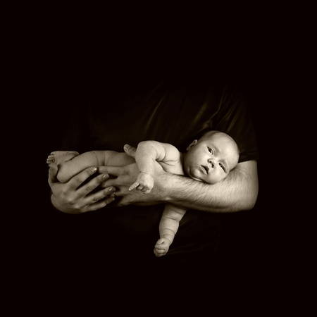 Newborn baby on the fathers hands