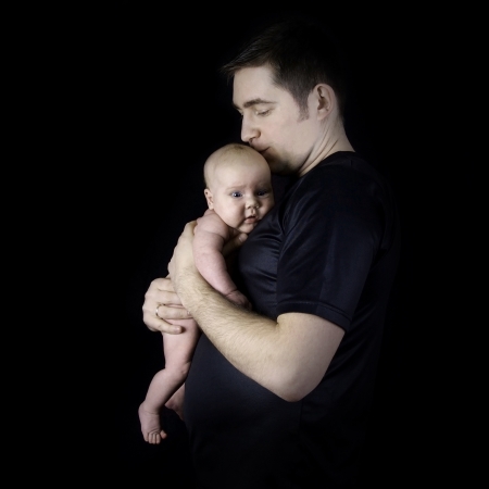 Newborn baby on the fathers handsの写真素材