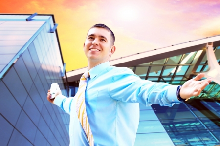 Hapiness Businessman standing on the business backgroundの写真素材