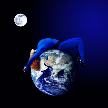 Woman in blue sleeping on the planet in space.の写真素材