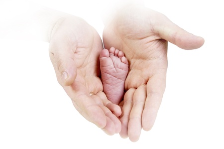 Babys foots in father hands on the monochrome backgroundの写真素材
