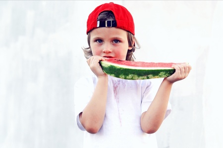 Child with part of watermelon, isolated on the white backgroundの写真素材