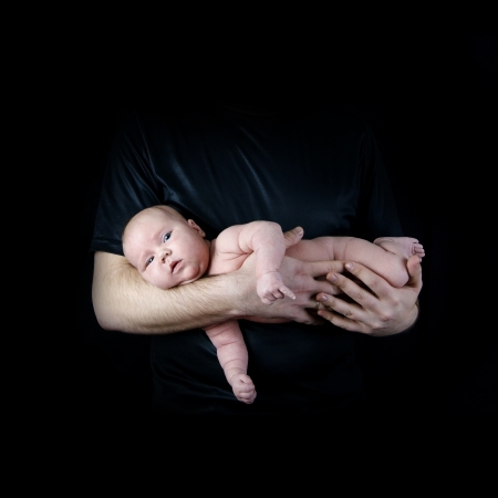 Newborn baby on the fathers handsの写真素材