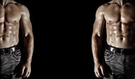 Bodybuilder posing on the black backgroundの写真素材