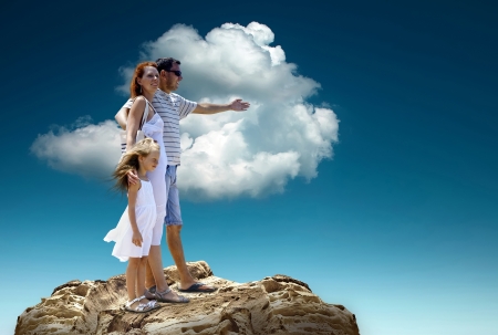 Family stay on the top of mountain, looking on the beautiful view.の写真素材