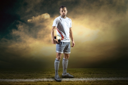 Soccer player with ball, outdoorsの写真素材