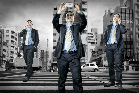 Businessman speaking by phone on the crossroadの写真素材