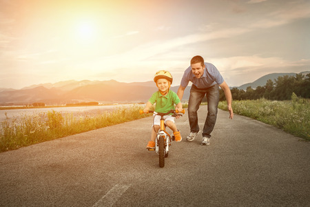 Happiness Father and son on the bicycle outdoorの写真素材