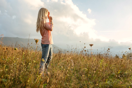 Happiness woman stay outdoor under sunlight of sunsetの写真素材