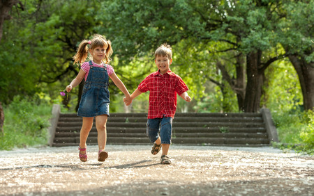 Happiness boy and girl fun outdoor under sunlightの写真素材