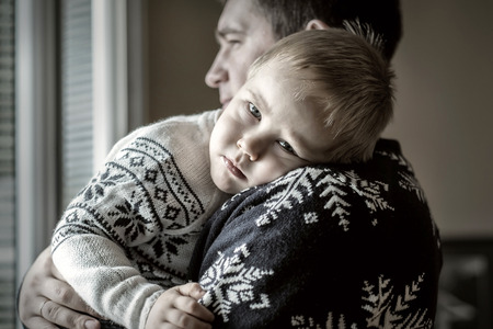 Father and son.Indoor near the window.の写真素材