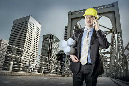 Architect in protective helmet speaking by phoneの写真素材