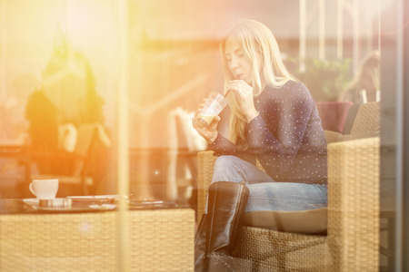 Happiness female with coffee. View through glass.の写真素材
