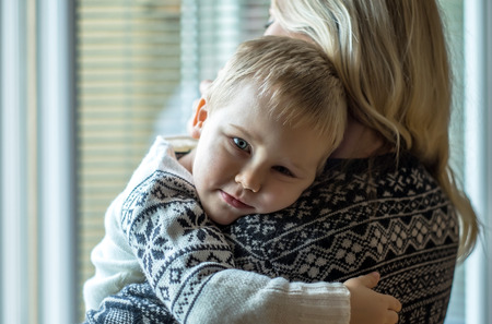 Mother and son lookings near the window.の写真素材