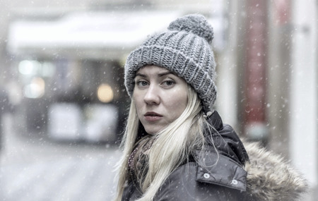Woman in grey winter hat in the cityの写真素材