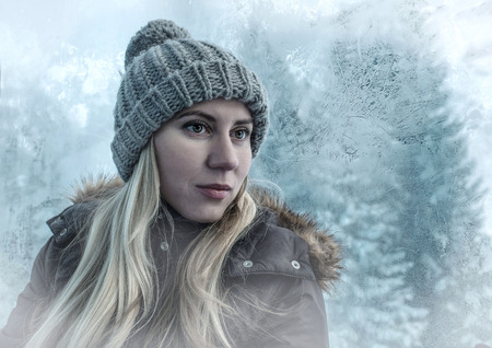 Portrait of a blonde woman in winter and frozen backgroundの写真素材