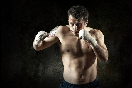Portrait of aggressiv boxer in blood