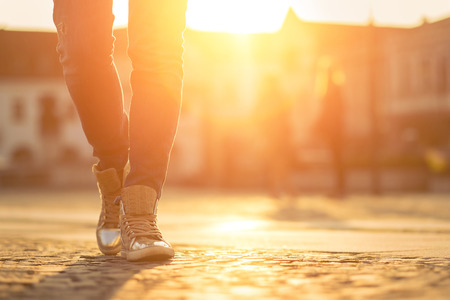 Womansfoots on the street at sunny day.の写真素材