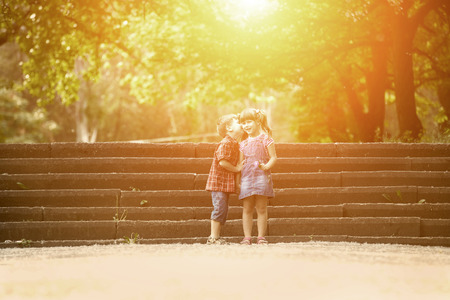 Happiness boy and girl with flower fun outdoor under sunlightの写真素材