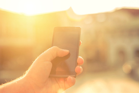 Man with telephone under sunlightの写真素材